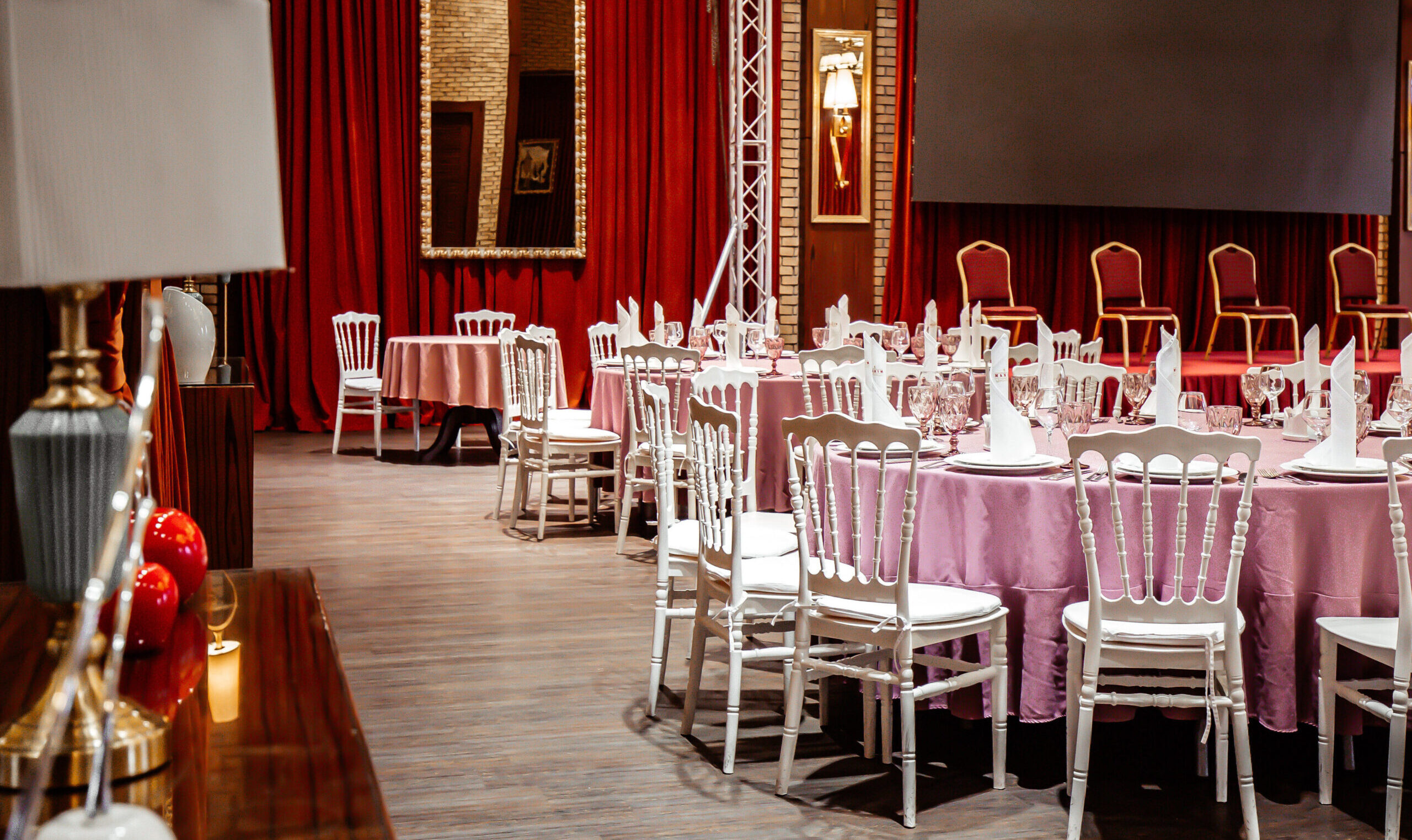 classic restaurant witn red curtains and stage